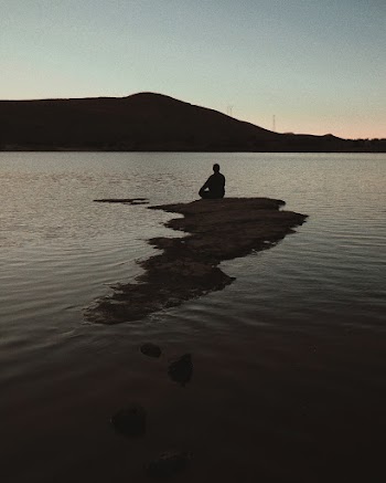 Man Sitting on Sea Rock