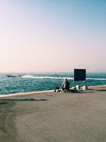 Man Sitting On Seashore 