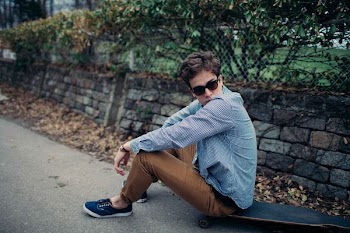 man sitting on skateboard during daytime