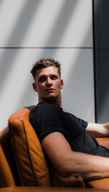 Man Sitting on Sofa Chair Looking Away
