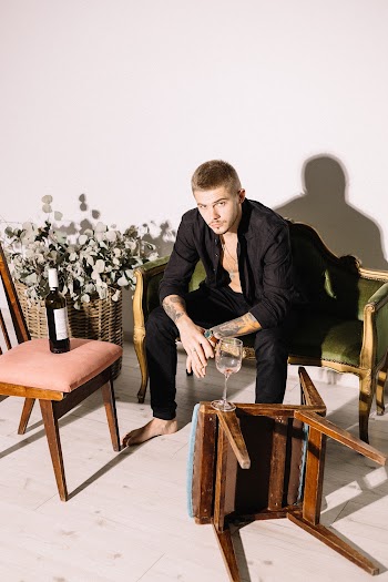 Man Sitting on Sofa Near Flowers