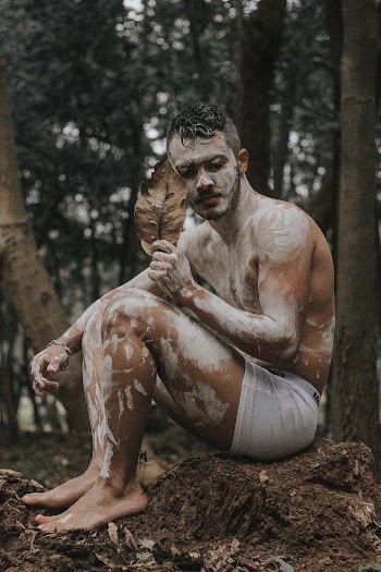 Man Sitting on Soil Near Trees