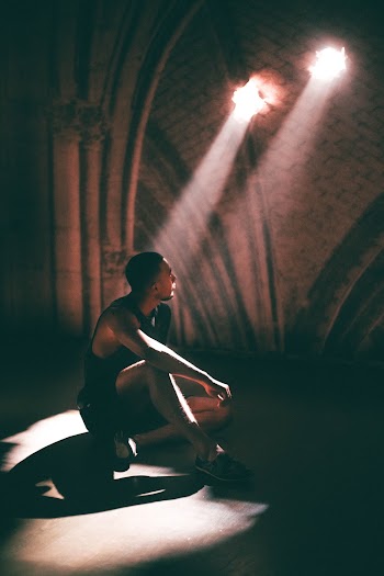 Man Sitting on Stage