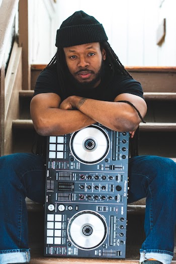 Man Sitting on Stairs Leaning on Dj Controller