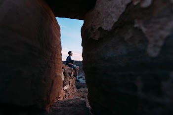 man sitting on stone