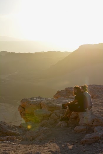 Man Sitting on Stone Beside Woman