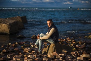 Man Sitting on Stone Under the Blue Sky