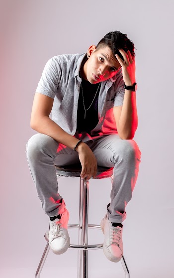 Man Sitting On Stool