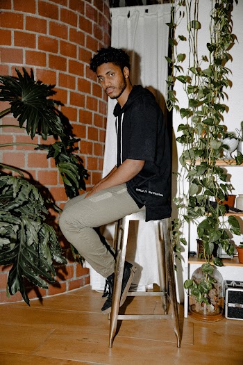 Man Sitting On Stool