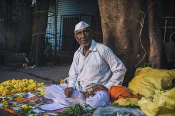 Man Sitting on Street Near Tree