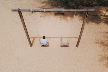 Man Sitting on Swing ]
