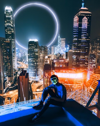 Man Sitting On Top Of Building