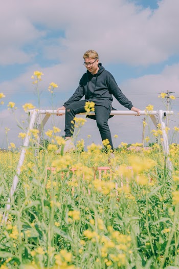 Man Sitting on Top of Swing Frame