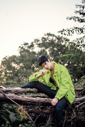Man Sitting on Tree Log