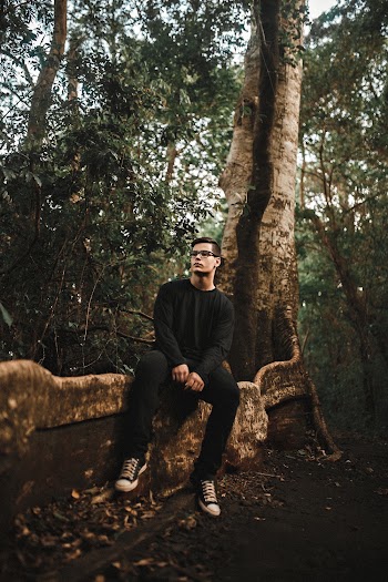 Man Sitting on Tree Root