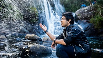 Man Sitting on Waterfalls