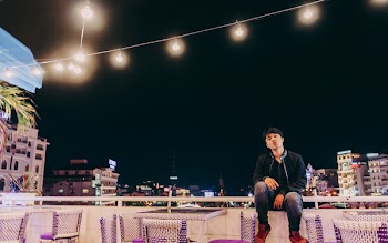 Man Sitting on White and Purple Chair
