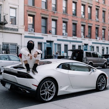 man sitting on white coupe