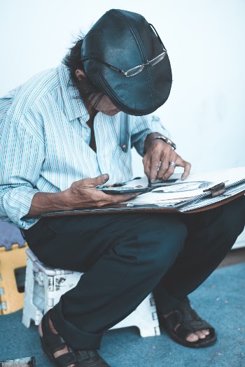 Man Sitting on White Ottoman