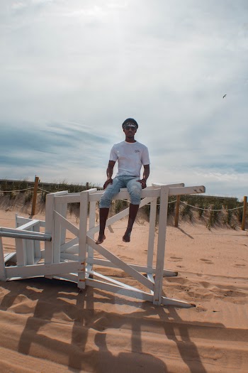 Man Sitting on White Wooden Frame on Dessert during Daytime