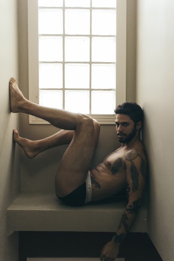 Man Sitting on Window Bench