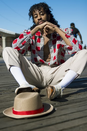 Man Sitting on Wooden Boardwalk