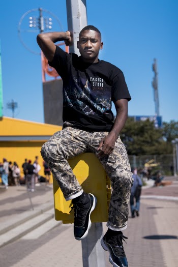 Man Sitting on Yellow Box On An Electric Post