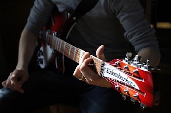 Man Sitting Playing Guitar
