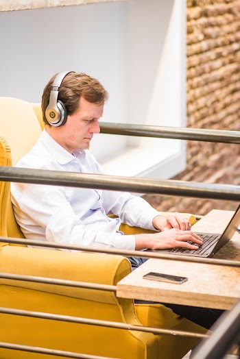 man sitting pn yellow chair