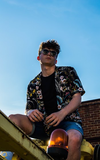 Man Sitting Under Blue Sky