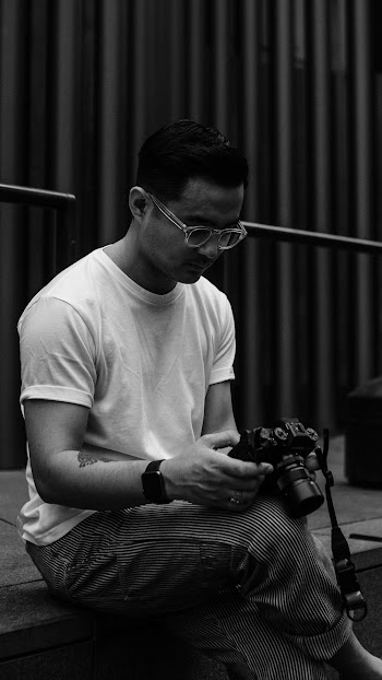 Man Sitting While Holding Dslr Camera