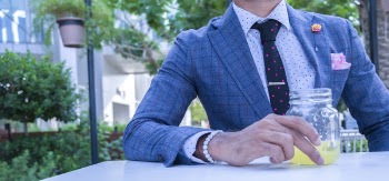 Man Sitting While Holding Half Filled Clear Glass 