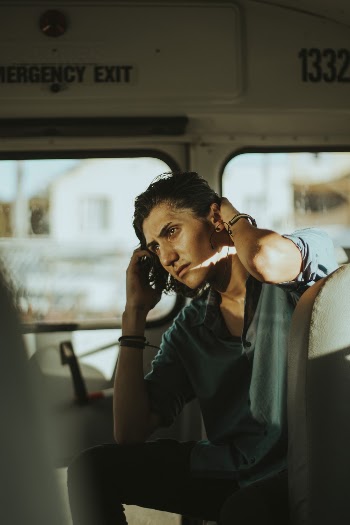 Man Sitting While Holding His Hair