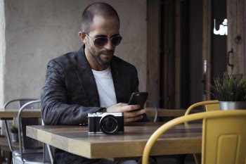 Man Sitting While Holding Mobile Phone