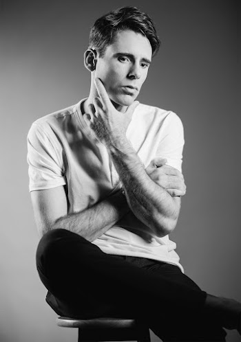Man Sitting While Touching His Jaw
