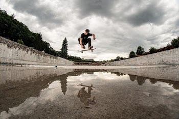 Man Skateboarding over Water