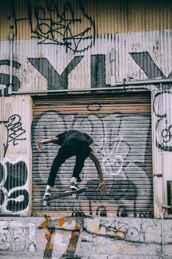 man skating near shutter door