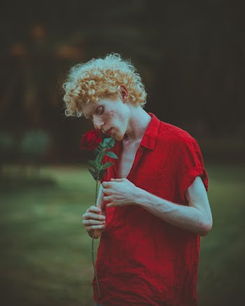 Man Smelling Red Rose