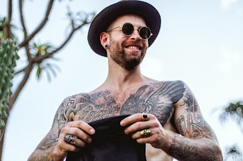Man Smiling While Holding Black Shirt