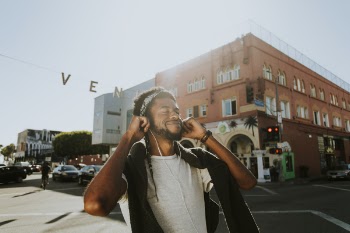 Man Smiling While Listening to Music