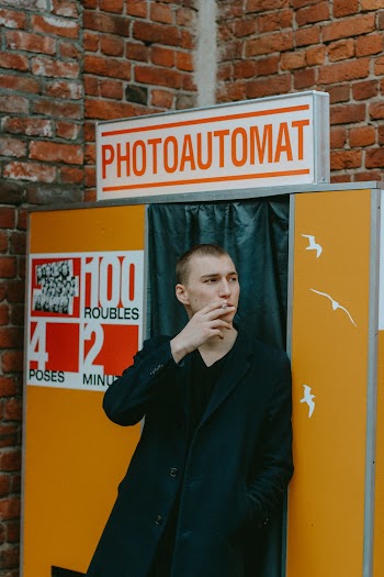 Man Smoking In Front Of Photo Booth