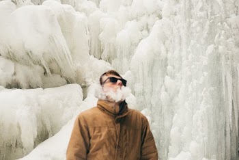 man smoking near ice wall