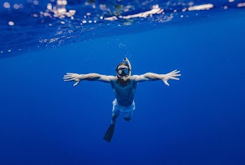 man snorkling underwater