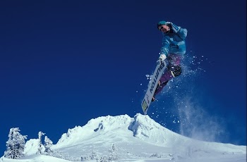 Man Snowboarding during Daytime