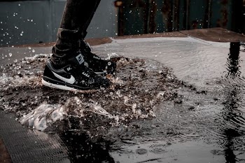 man splashing water on ground