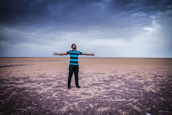 Man Spreading His Arms Wide Open on Field