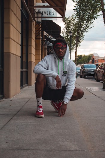 Man Squats Near Forever 21 Fashion Boutique