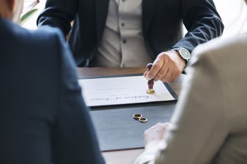 Man Stamping on White Document