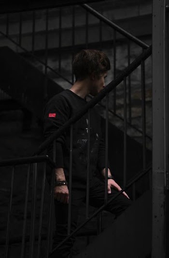 man stand on black metal stair
