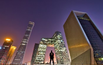 Man Standing Across Buildings